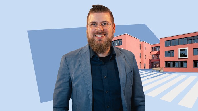 Ein Mann steht vor einem blauen Hintergrund. Im Hintergrund steht ein rotes Haus.